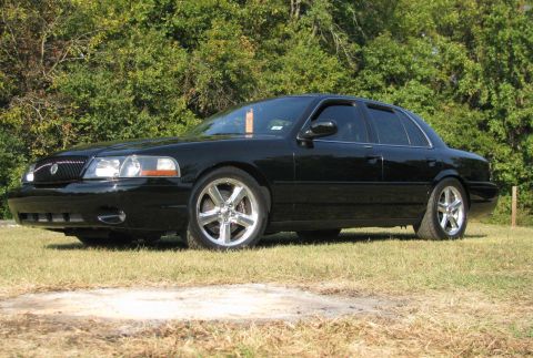 2003 Mercury Marauder - A black 2003 Mercury Marauder is shown from the front three-quarter view on a grassy area.