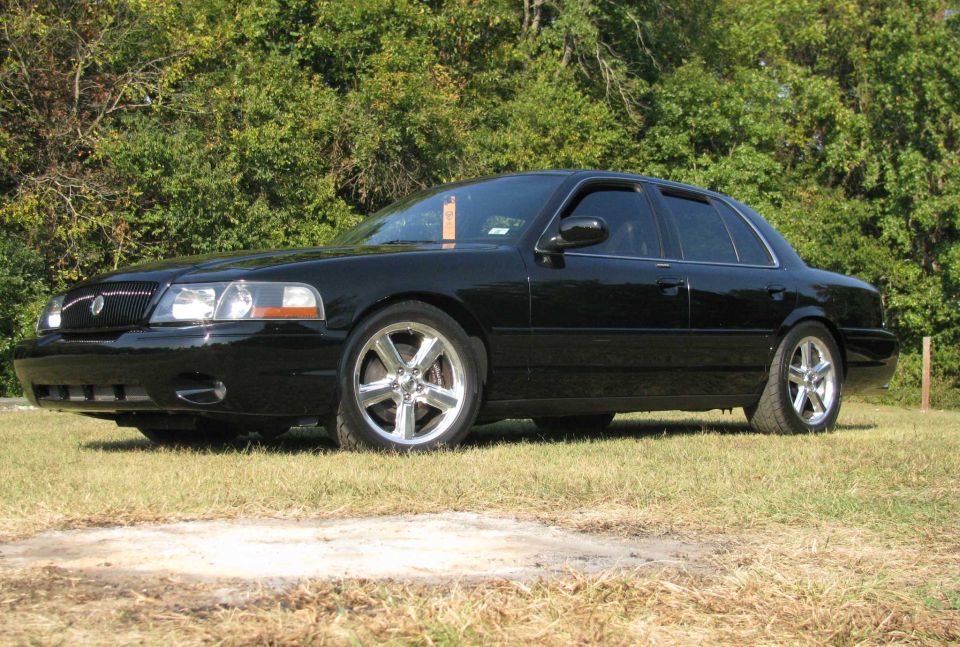 2003 Mercury Marauder parked on grass with trees in background