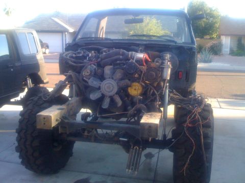 1994 Ford Bronco - Vehicle engine and chassis are exposed, indicating repair or modification work is underway.