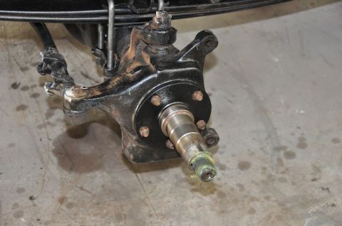 1996 Ford Bronco - Close-up of a vehicle's front wheel hub and steering knuckle assembly, showing mechanical components.