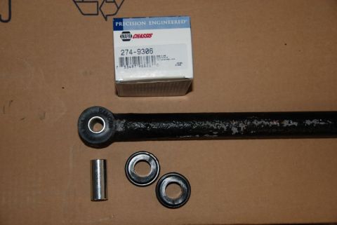 1996 Ford Bronco - NAPA Chassis part 274-9386 and associated hardware laid out on a cardboard surface.
