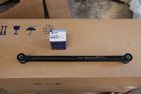 1996 Ford Bronco - A NAPA Auto Parts box sits next to a vehicle suspension arm on a cardboard box.