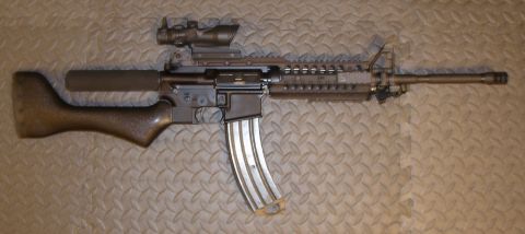 1990 Ford Bronco - An assault rifle with a scope and extended magazine is displayed against a textured background.