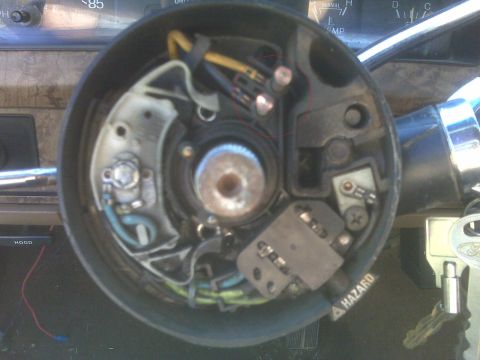 1986 Ford Bronco - Close-up view of the steering column interior of a 1986 Ford Bronco, showing wiring and the hazard light switch.