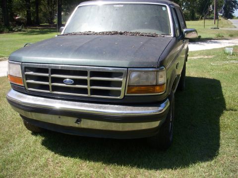 1993 Ford Bronco - Front view of a 1992 Ford Bronco parked on grass.