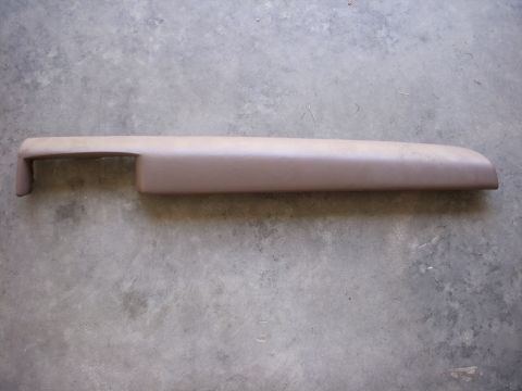 1993 Ford Bronco - A tan dashboard trim piece is shown against a concrete background.