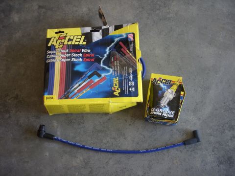 1993 Ford Bronco - A set of Accel spark plug wires and a box of Accel U-Groove spark plugs are laid out on a concrete surface.