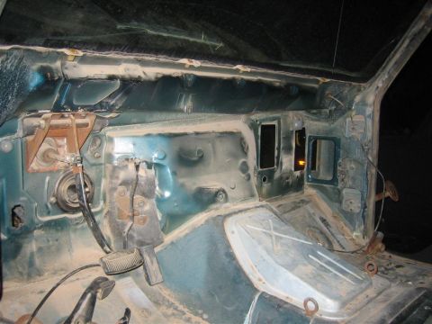 1994 Ford Bronco - Interior of a vehicle undergoing disassembly, revealing the firewall and pedal assembly.