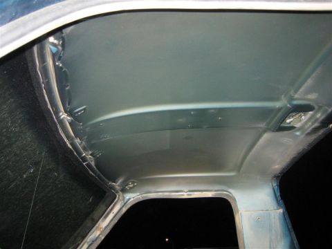 1994 Ford Bronco - The interior ceiling of a vehicle shows signs of wear and potential water damage around the window frames.