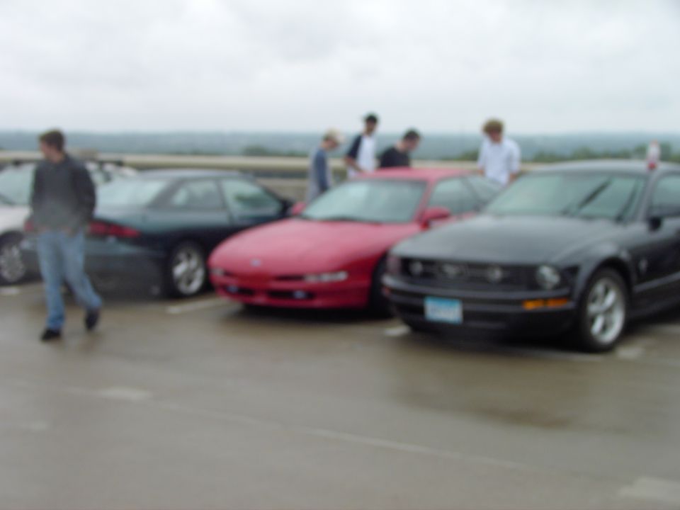 Red sports car and black sports car parked side-by-side