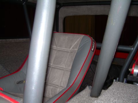 1986 Ford Bronco - Interior view of a vehicle's racing seat and roll cage.