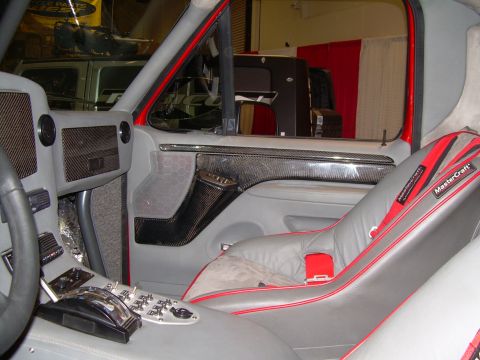 1986 Ford Bronco - Interior view of a custom truck with racing seats and a heavily modified dashboard and center console.