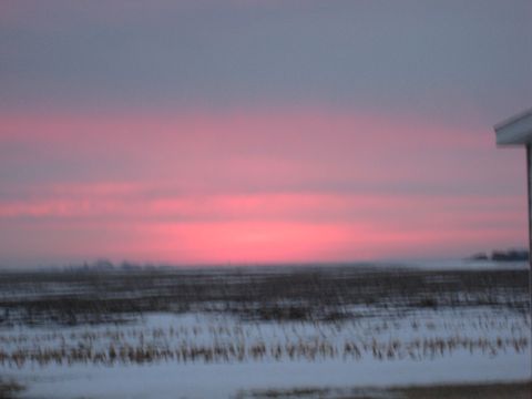 2001 Ford Crown Victoria - A winter sunset paints the sky with vibrant pink and gray hues over a snow-covered field.