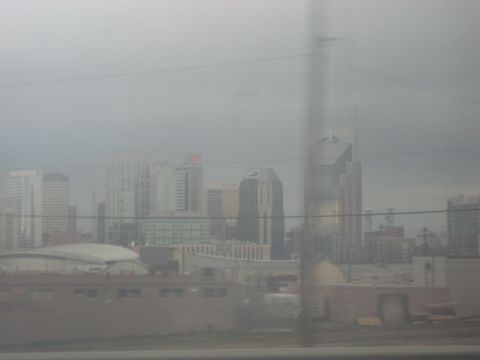 2001 Ford Crown Victoria - A hazy view of a city skyline with various buildings and a prominent logo at the bottom.