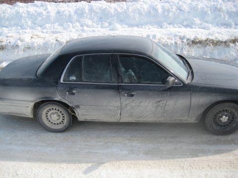 2001 Ford Crown Victoria - Black 2001 Ford Crown Victoria parked on a snow-covered road.