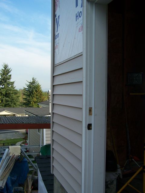 1988 Suzuki Samurai - Exterior of a house showing siding installation and construction materials.