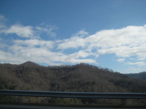 2001 Ford Crown Victoria - A scenic view of mountains under a partly cloudy sky, with a guardrail visible in the foreground.