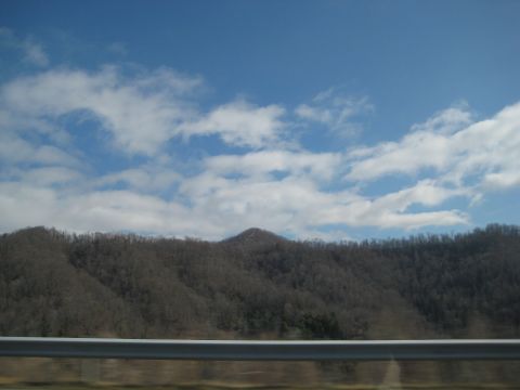 2001 Ford Crown Victoria - A scenic view of mountains and clouds, possibly taken from a moving vehicle.