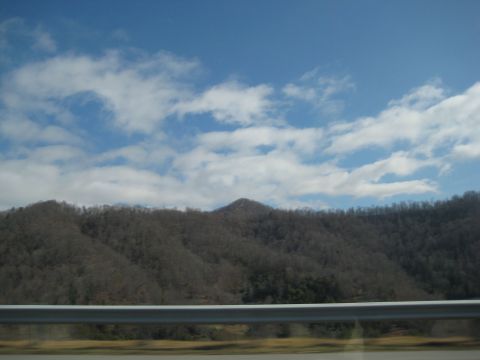 2001 Ford Crown Victoria - A view of mountains and sky from a moving vehicle, with a guardrail visible.