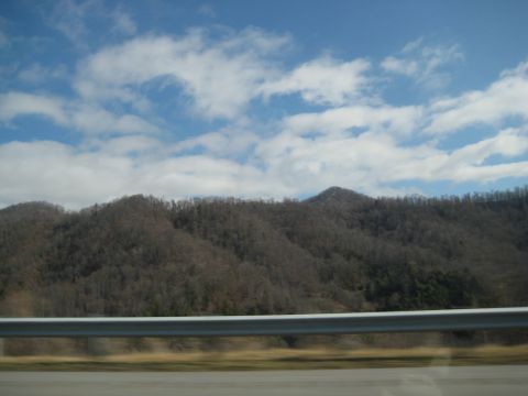 2001 Ford Crown Victoria - A scenic view of mountains and sky, likely captured from a moving vehicle on a highway.