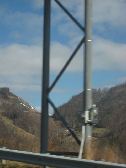 2001 Ford Crown Victoria - View of a mountainous landscape from a vehicle, with a utility pole and guardrail in the foreground.