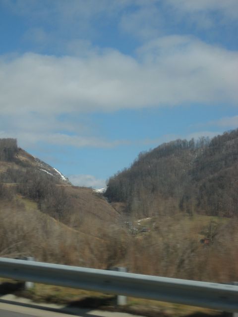 2001 Ford Crown Victoria - A view of rolling hills and mountains under a cloudy sky, with a guardrail visible in the foreground.
