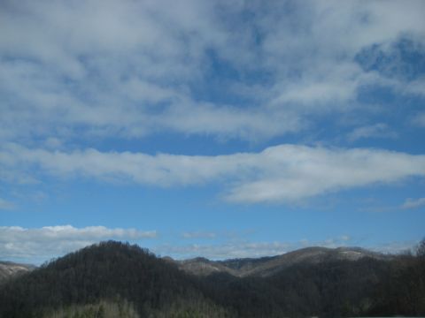 2001 Ford Crown Victoria - A scenic view of rolling mountains under a partly cloudy sky.