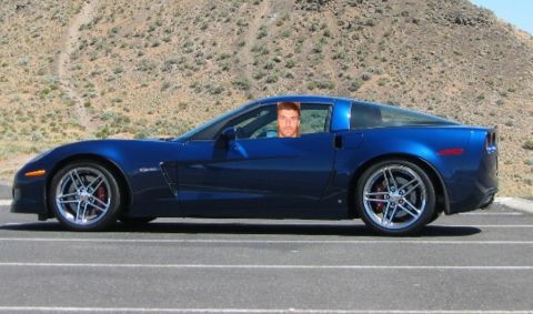 1998 Ford Taurus - A blue sports car, likely a C6 Corvette, is seen from the side with a man visible in the driver's window.