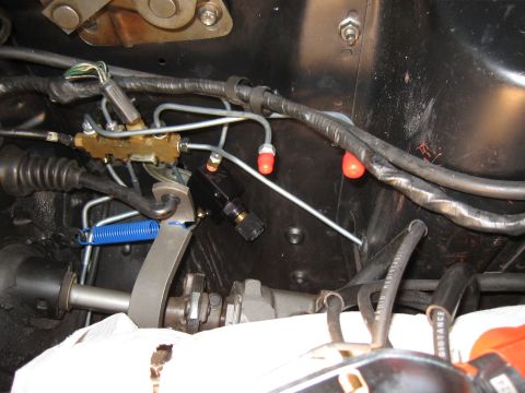 1968 Shelby GT500 - Close-up of a proportioning valve and brake lines, likely from an older vehicle's engine bay.