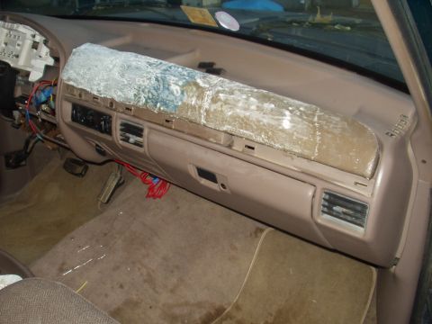 1993 Ford Bronco - The interior of a vehicle shows exposed wiring and a damaged dashboard cover, suggesting a 1992 model year.