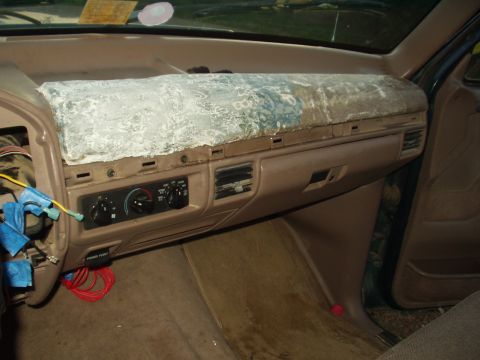 1993 Ford Bronco - Interior view of a vehicle's dashboard, showing exposed wiring and a damaged dash cover.