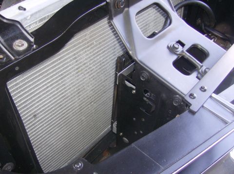 1970 Ford Ranchero - Close-up view of a vehicle's radiator and its supporting bracketry.