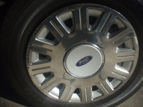 2003 Ford Crown Victoria - Close-up of a Ford wheel cover with a visible Ford logo.