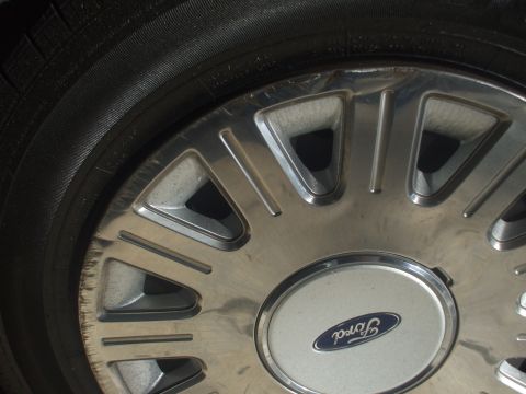 2003 Ford Crown Victoria - This image shows a close-up of a Ford wheel, the brand's oval logo.