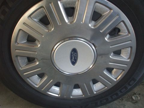 2003 Ford Crown Victoria - This is a close-up of a Ford wheel cover, not a full vehicle.