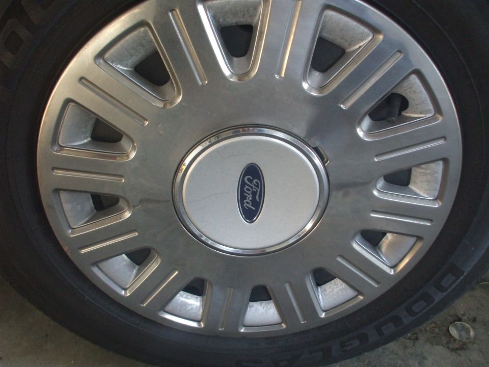 Close-up of a Ford wheel cover with the Ford logo in the center