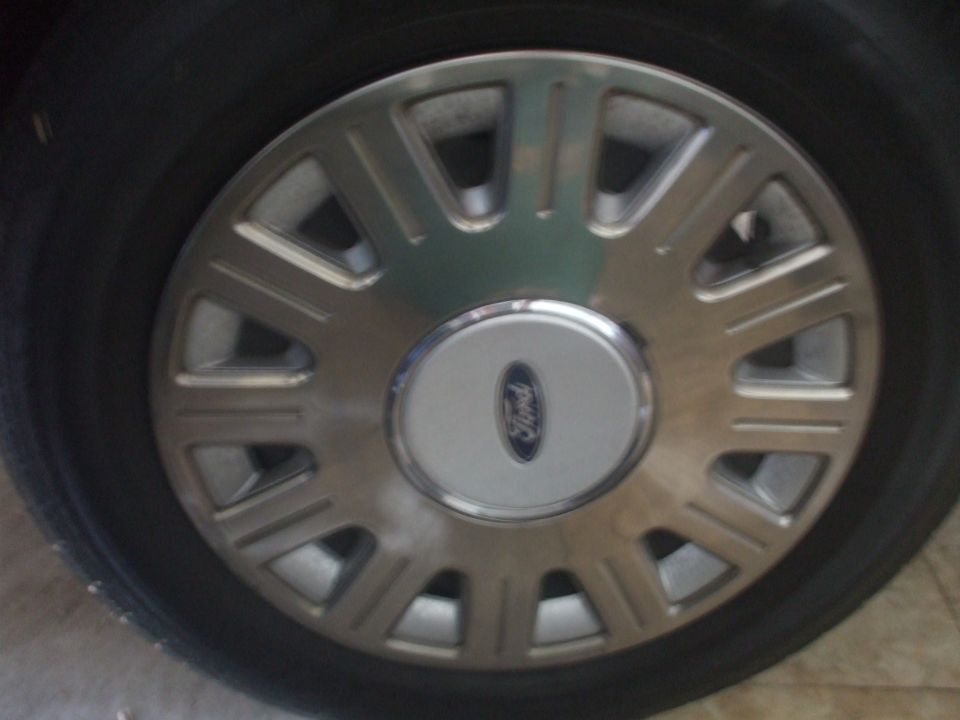 Wheel with a Ford logo on a 2003 Ford Crown Victoria