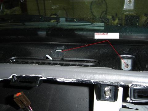 2007 Ford Mustang - Close-up view of the dashboard interior, highlighting the location of 7mm bolts and exposed wiring.