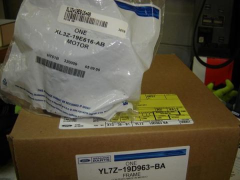 2007 Ford Mustang - Two boxes containing Ford genuine parts are shown, one with a label for a motor and another for a frame.
