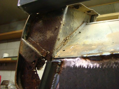 1948 Jeep Wrangler - Close-up of a heavily rusted metal frame section, showing signs of repair and welding.