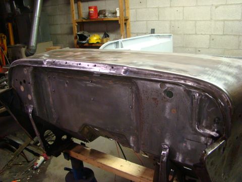 1948 Jeep Wrangler - Unidentified car body panel undergoing repair work in a workshop setting.