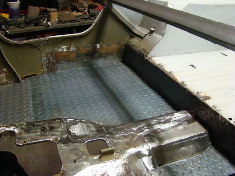 1948 Jeep Wrangler - The interior floor of a vehicle is shown with diamond plate and metal work, indicating ongoing repairs.