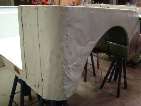 1948 Jeep Wrangler - Jeep CJ body tub section undergoing repair or restoration in a workshop setting.