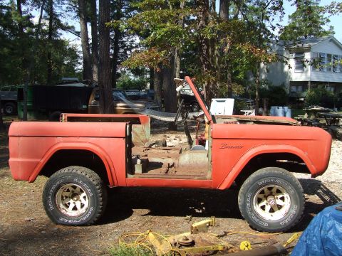 1967 Ford Bronco - Side view of a 1967 Ford Bronco body undergoing restoration outdoors.