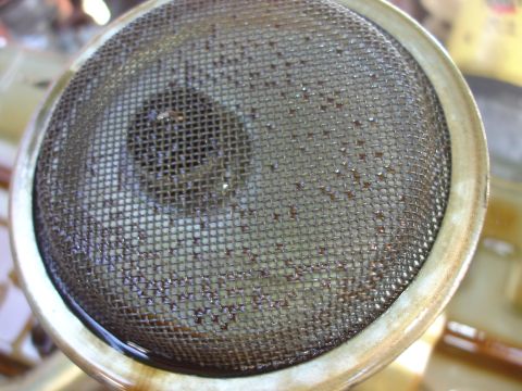 1993 Ford Taurus - Close-up of a dirty oil strainer, indicating potential engine issues.