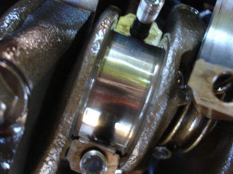 1993 Ford Taurus - Close-up of a damaged engine crankshaft bearing, indicating potential internal engine issues.