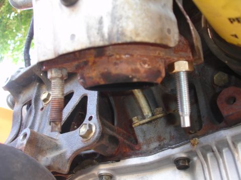 1993 Ford Taurus - Engine part showing signs of rust and wear, with visible bolts and hoses.