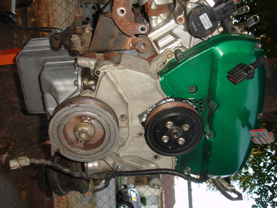 Green engine cover with pulleys and sensors
