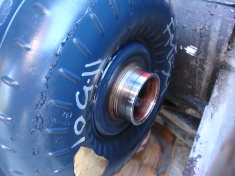 1993 Ford Taurus - Close-up of a blue torque converter with handwritten markings, showing wear on the outer edge.