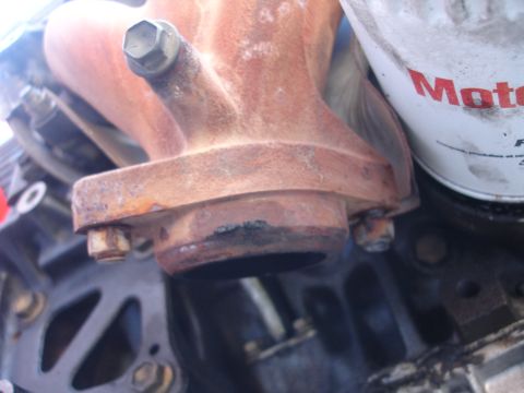 1993 Ford Taurus - Exhaust manifold and oil filter assembly on an engine.